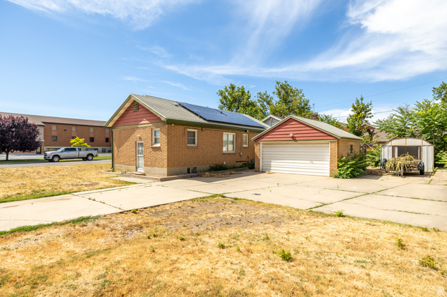 193 Locust Street Clearfield, UT 84015 - Photo 3 of 29 Brick exterior with a gabled roof and integrated solar panels