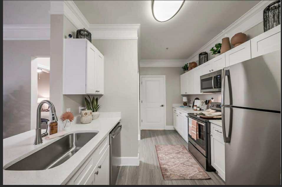 529 Barker-Clodine Road, Unit VERBANA Houston, TX 77094 - Photo 14 of 17 a kitchen with a refrigerator sink and stainless steel appliances