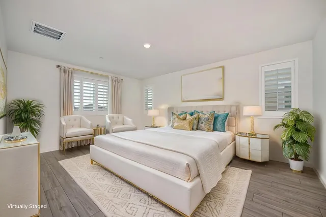 a bedroom with a bed and a potted plant