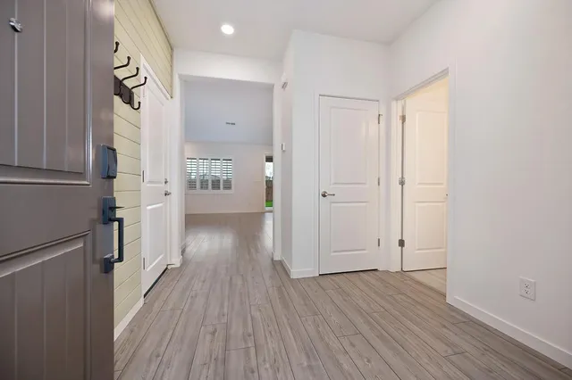 a view of hallway with wooden floor