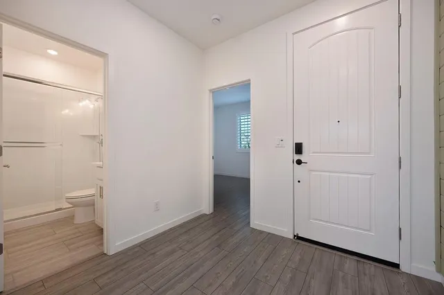 wooden floor in an empty room with a window