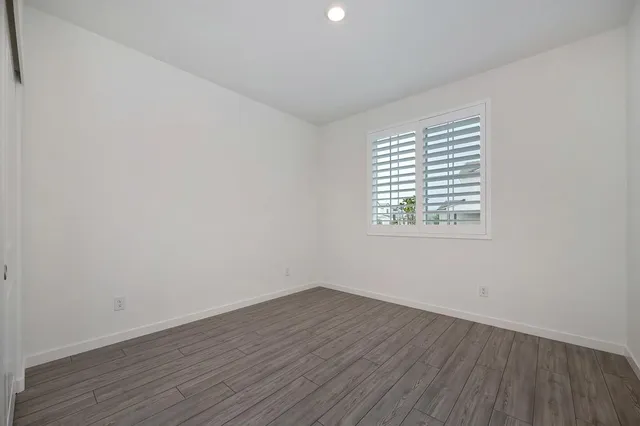 a bedroom with bed and a potted plant