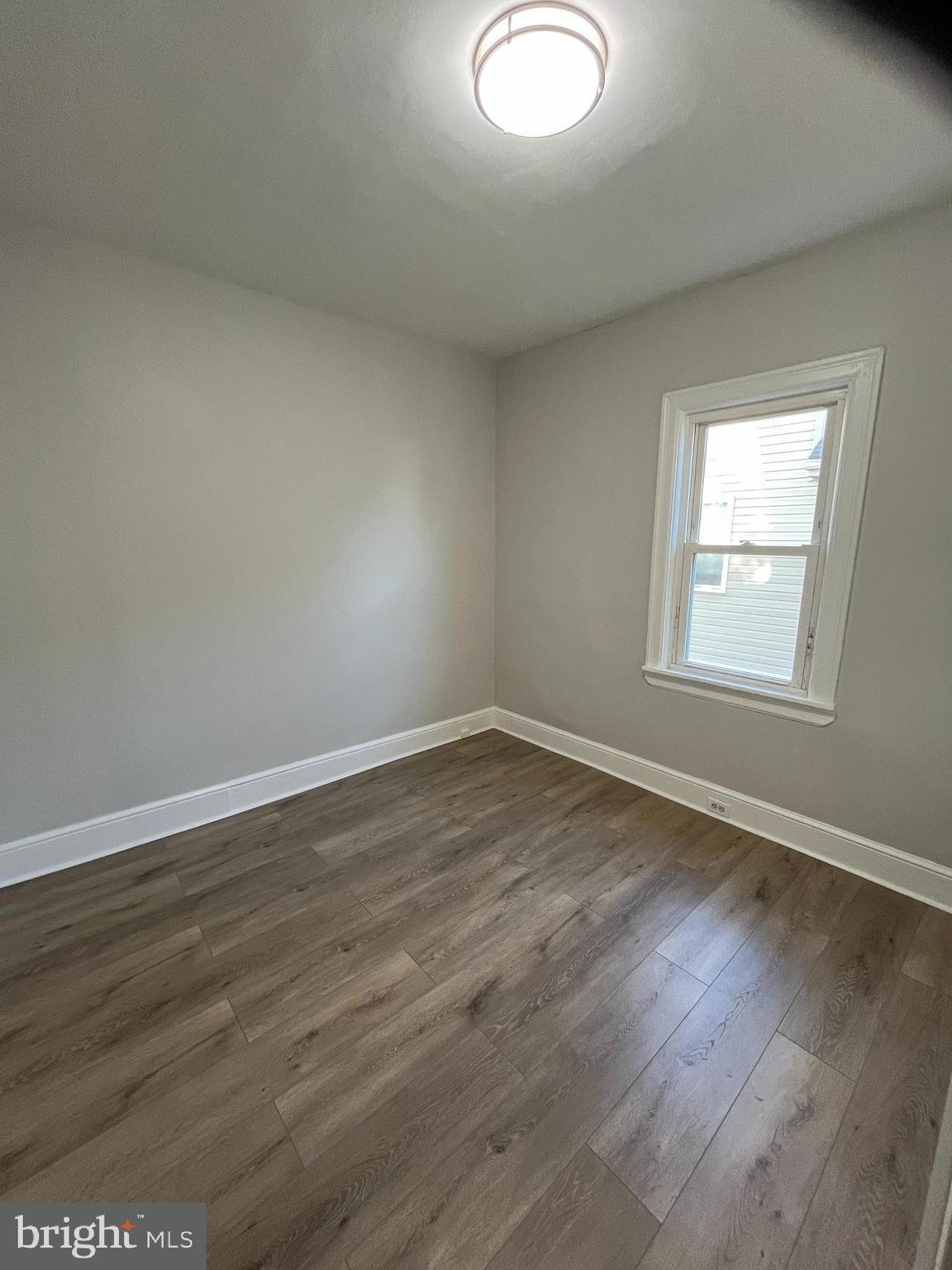 105 Mecray Lane Maple Shade, NJ 08052 - Photo 11 of 32 an empty room with wooden floor and windows