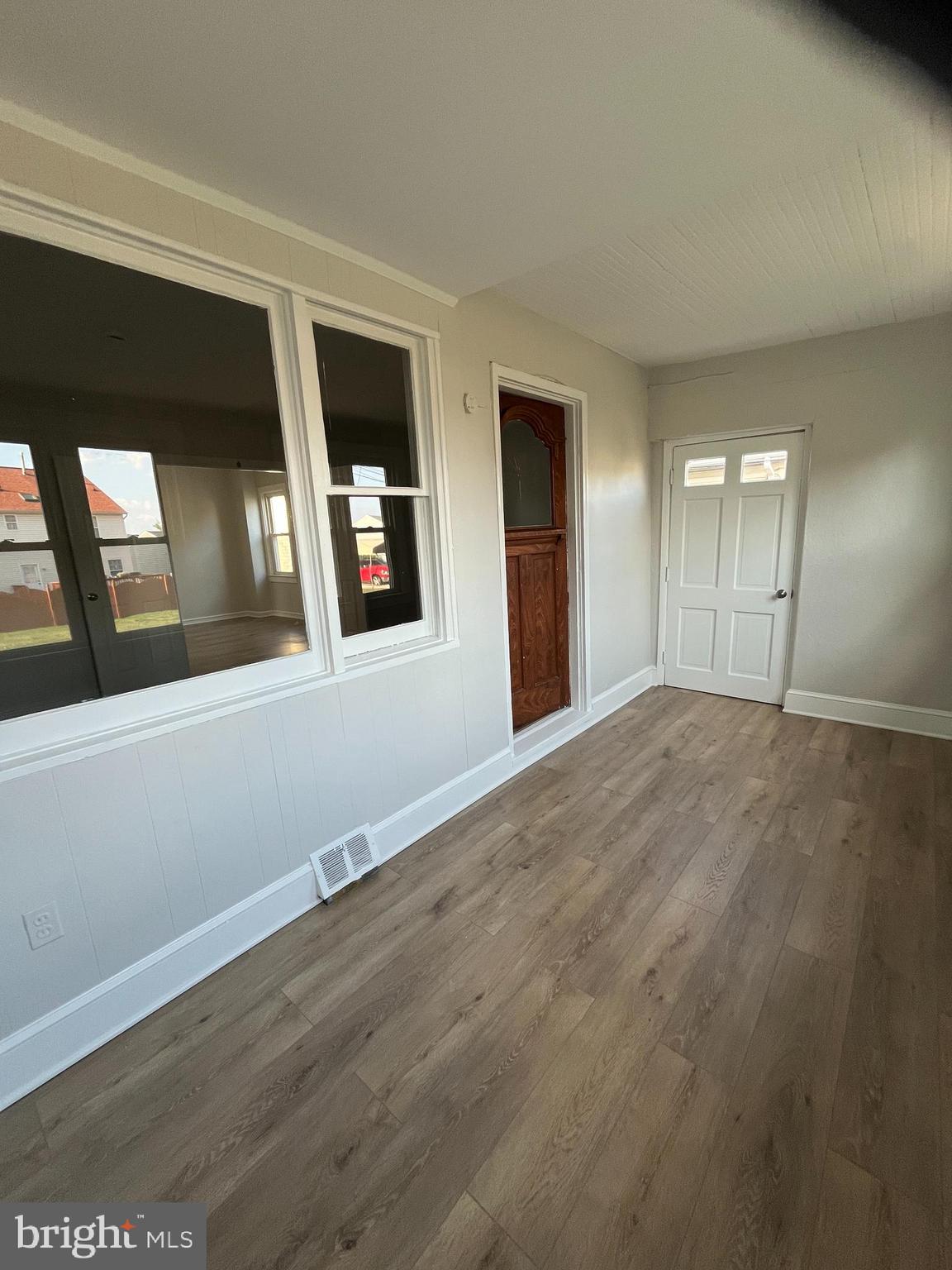 105 Mecray Lane Maple Shade, NJ 08052 - Photo 4 of 32 a view of an empty room with wooden floor and a window