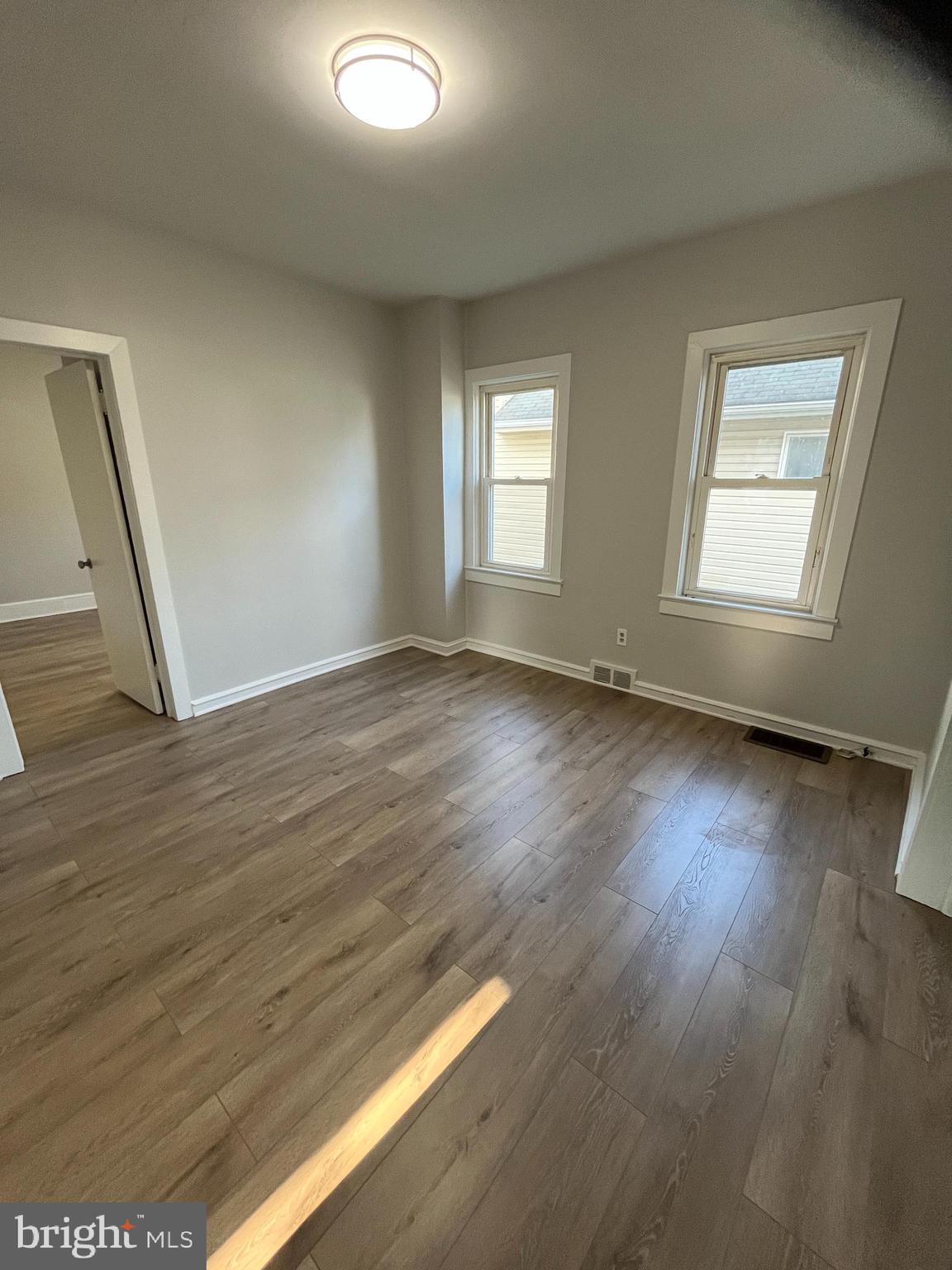 105 Mecray Lane Maple Shade, NJ 08052 - Photo 5 of 32 a view of an empty room with wooden floor and a window