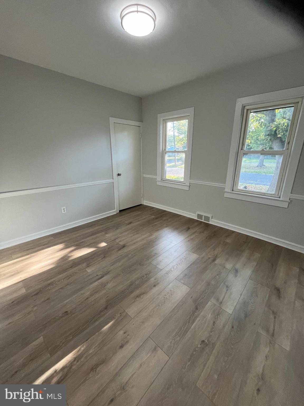 105 Mecray Lane Maple Shade, NJ 08052 - Photo 6 of 32 an empty room with wooden floor and windows