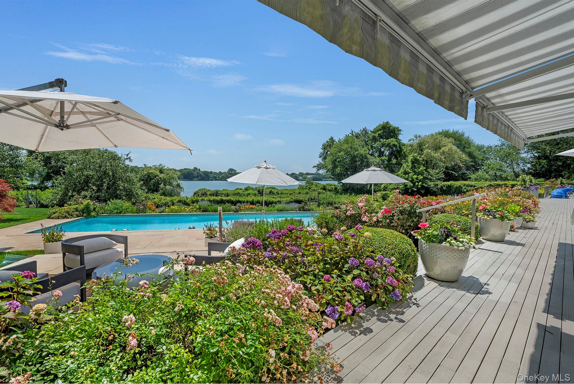 316 Deerfield Road Water Mill, NY 11976 - Photo 11 of 22 a view of a table and chairs under an umbrella