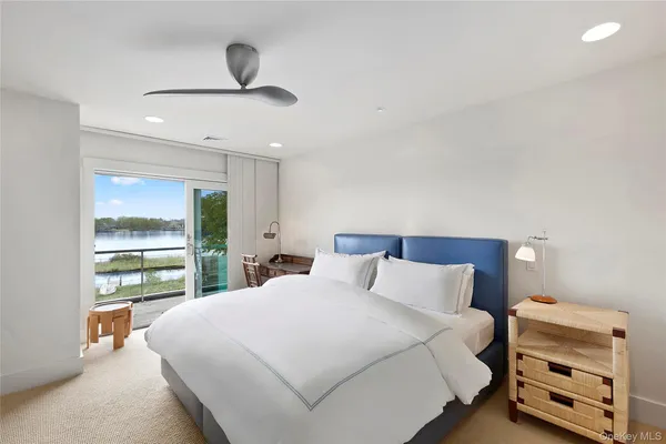 a bedroom with a bed and a large window