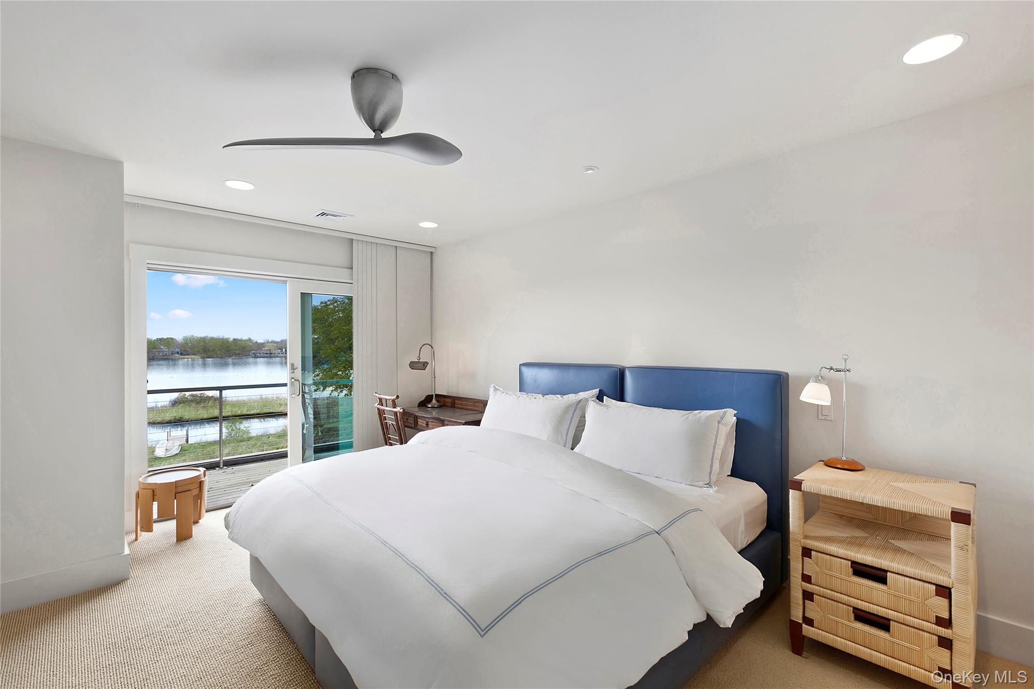 316 Deerfield Road Water Mill, NY 11976 - Photo 16 of 22 a bedroom with a bed and a large window