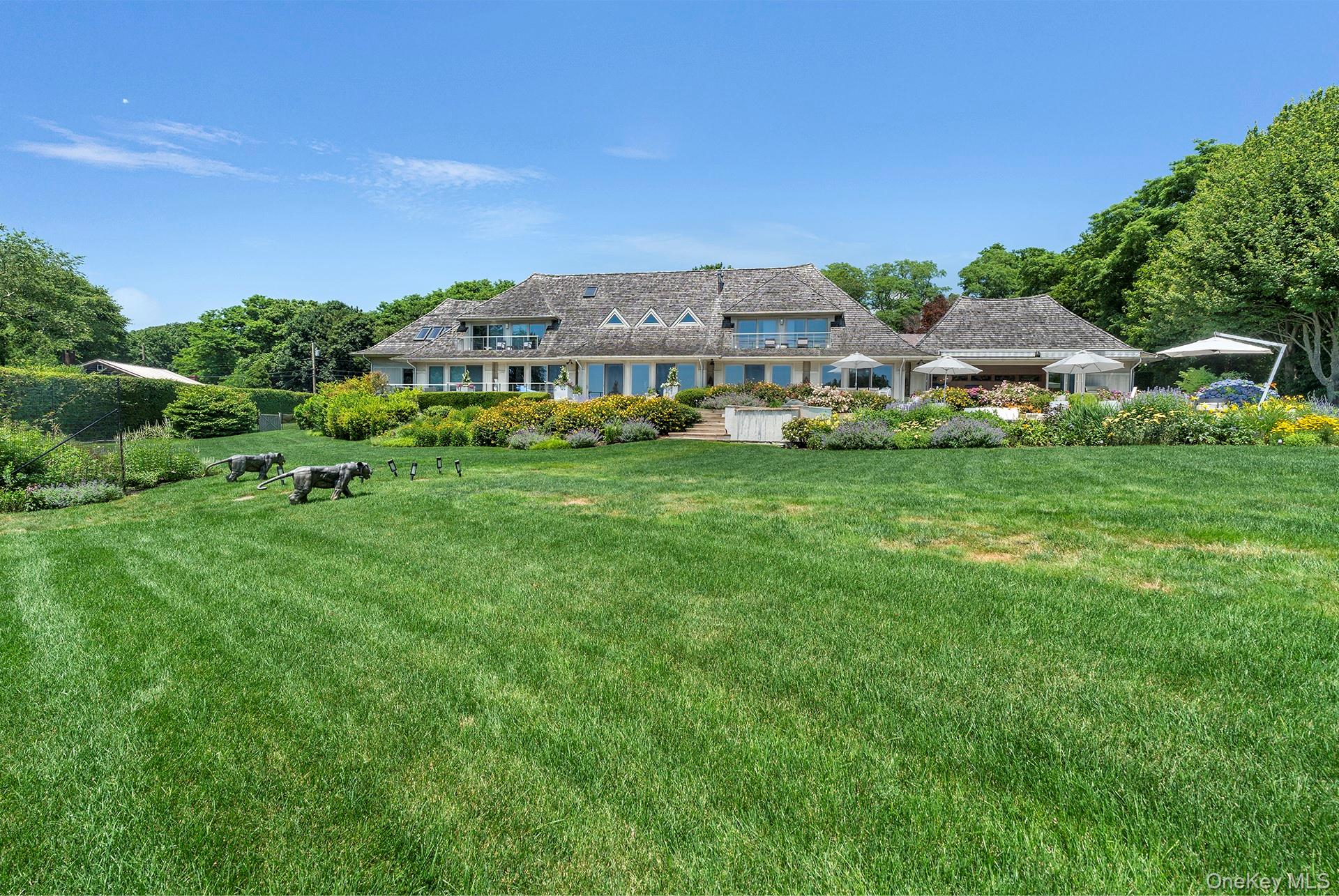 316 Deerfield Road Water Mill, NY 11976 - Photo 2 of 22 a aerial view of a house with a big yard and large trees