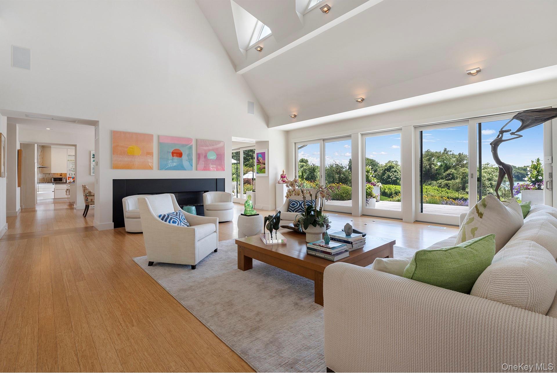 316 Deerfield Road Water Mill, NY 11976 - Photo 3 of 22 a living room with fireplace furniture and a large window