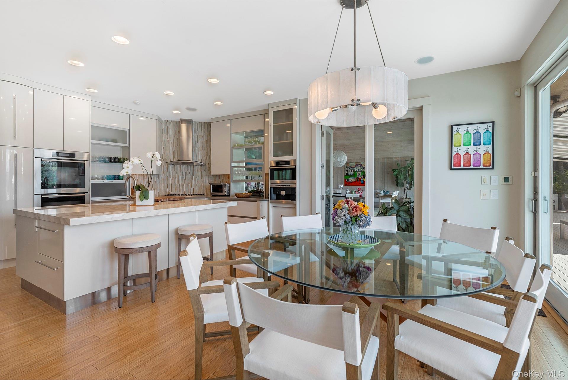 316 Deerfield Road Water Mill, NY 11976 - Photo 5 of 22 a view of a dining room with furniture a chandelier and wooden floor