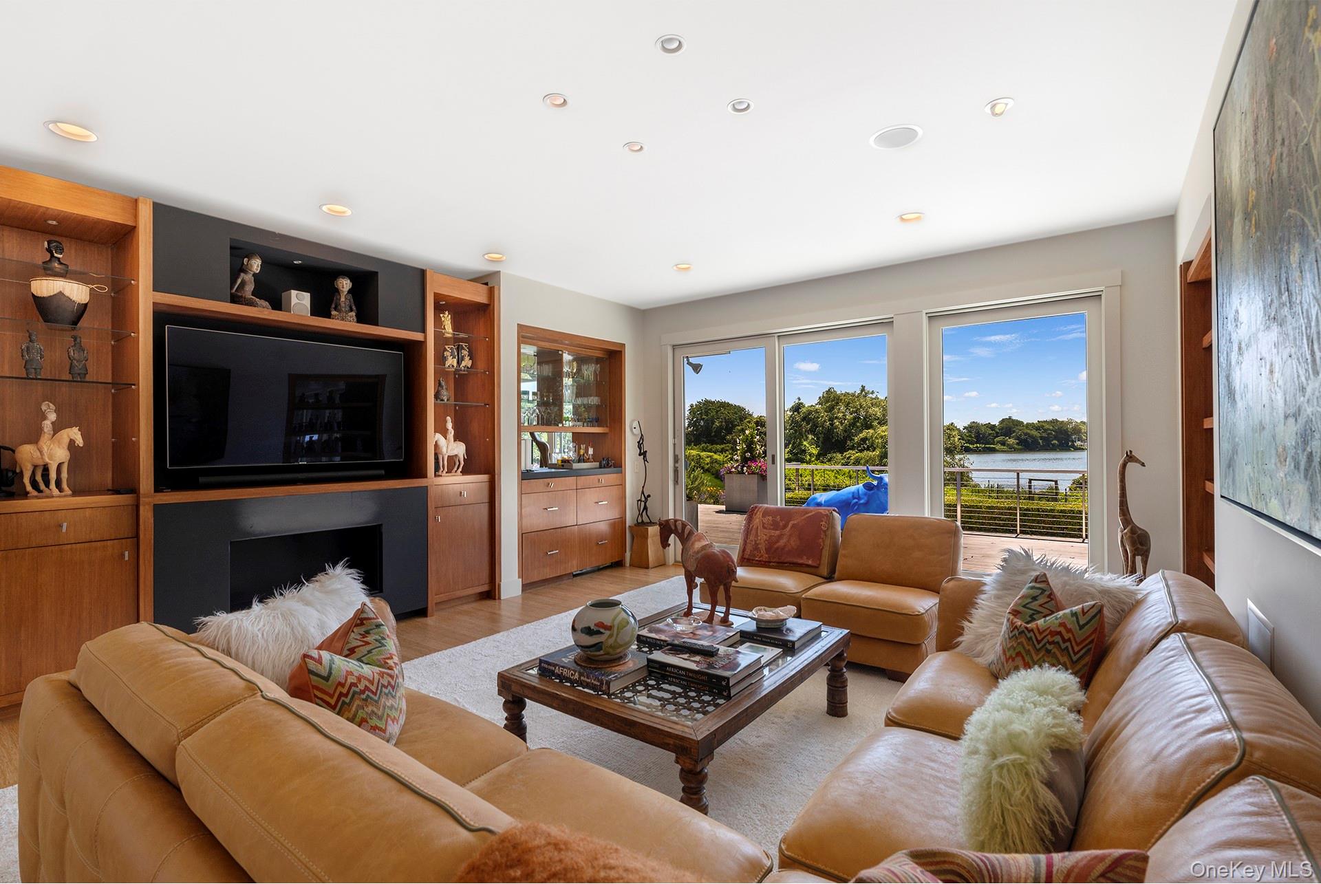 316 Deerfield Road Water Mill, NY 11976 - Photo 7 of 22 a living room with furniture large window and a flat screen tv
