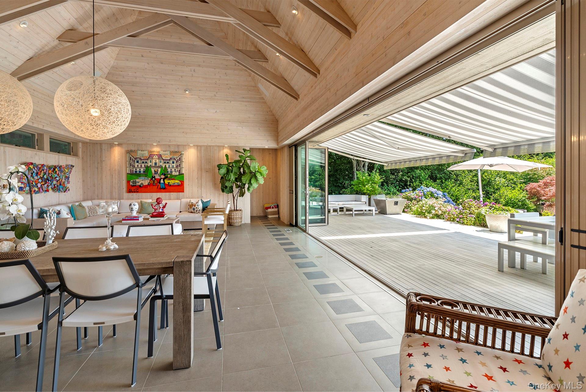 316 Deerfield Road Water Mill, NY 11976 - Photo 9 of 22 a dining room with furniture and a large window