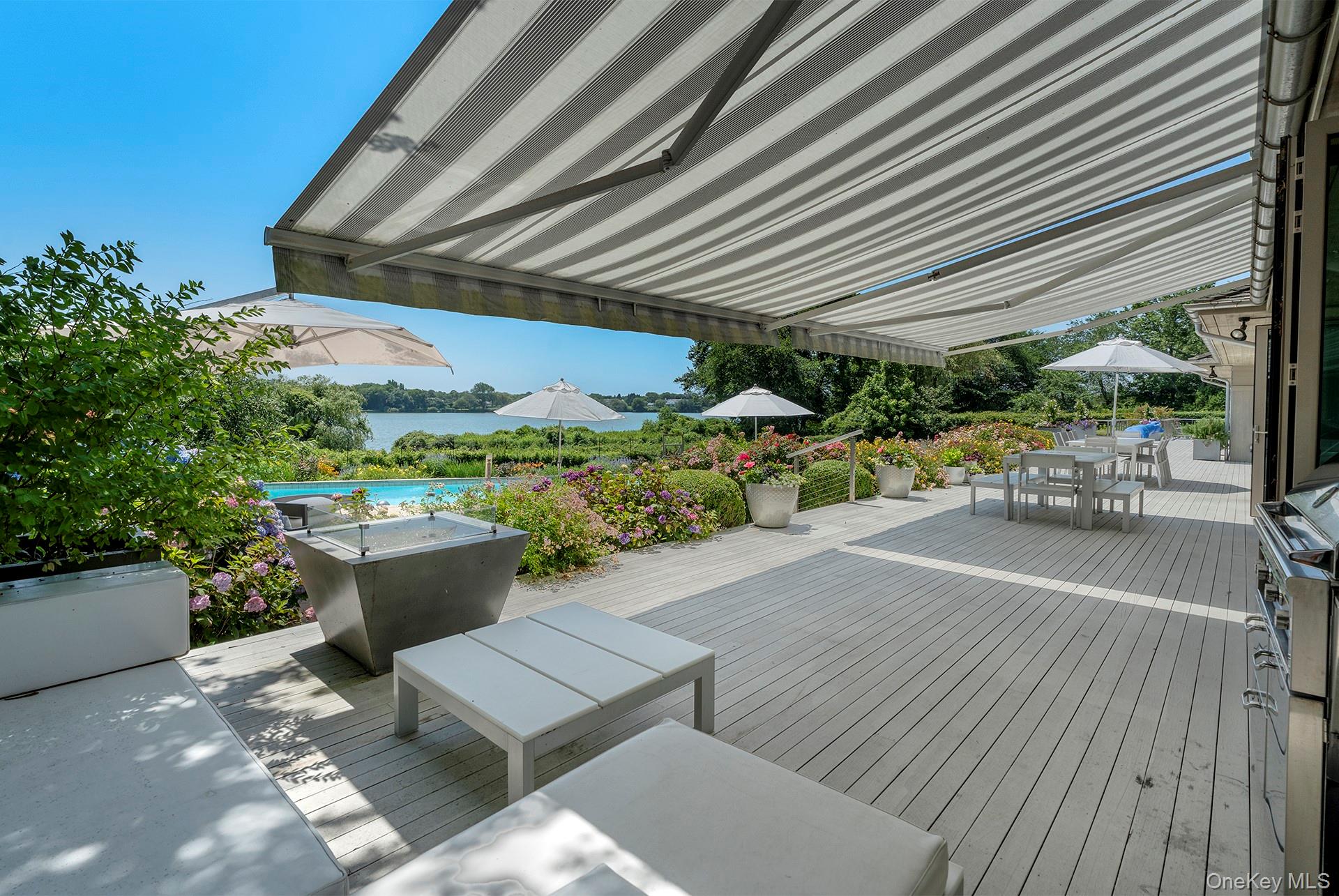 316 Deerfield Road Water Mill, NY 11976 - Photo 10 of 22 a view of a patio with table and chairs and potted plants