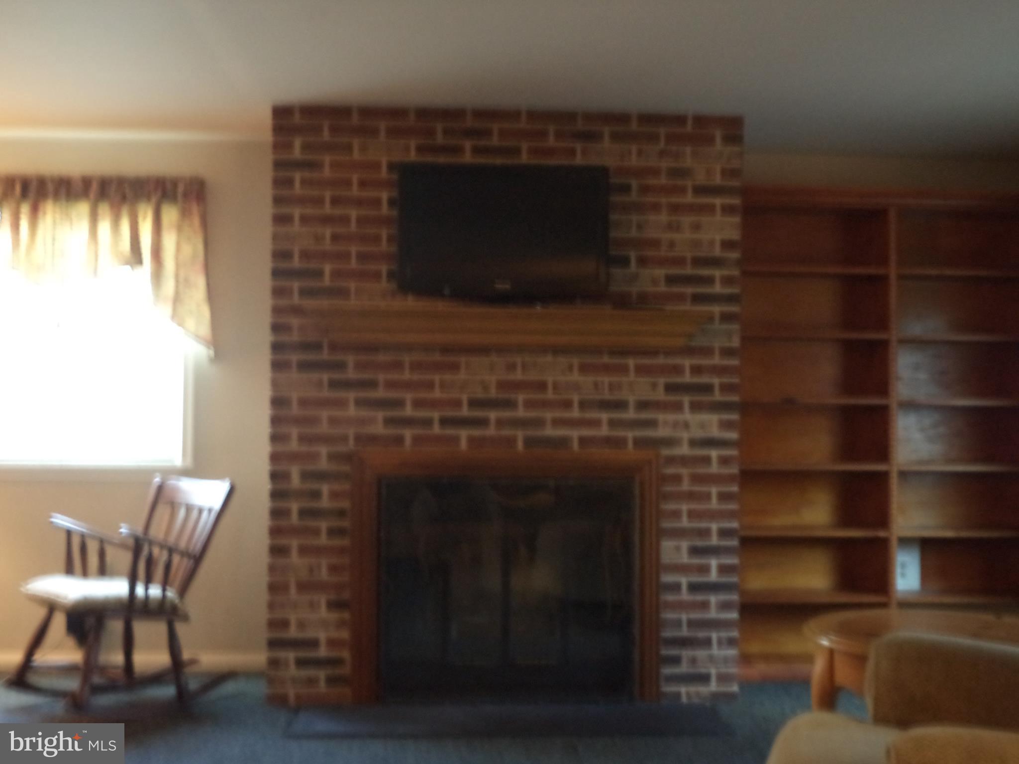 2200 Maple Road Baltimore, MD 21219 - Photo 25 of 25 Brick fireplace with mantle n living room