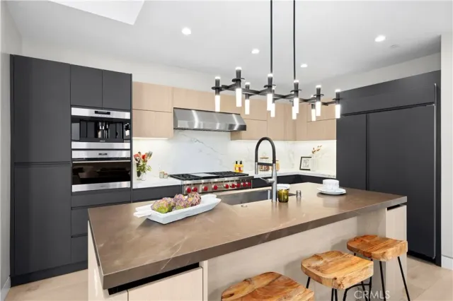 a kitchen with kitchen island cabinets a counter space and stainless steel appliances