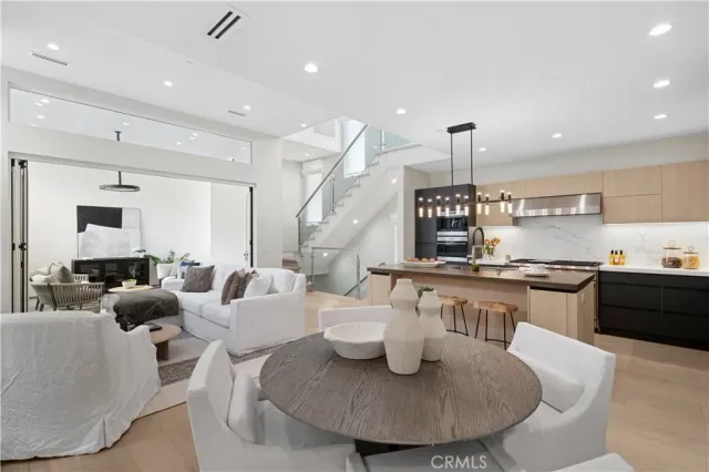 a living room with furniture kitchen and a table