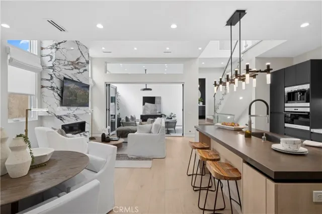 a kitchen with kitchen island a large counter top space appliances and cabinets
