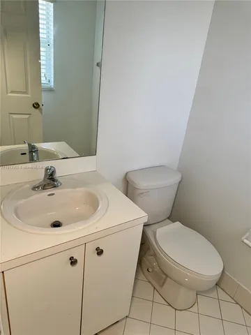 a white toilet sitting next to a bathroom sink