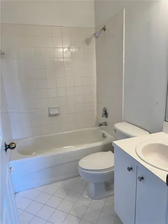 a bathroom with a toilet a sink and bathtub
