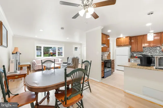 a dining room with furniture a window and a kitchen view
