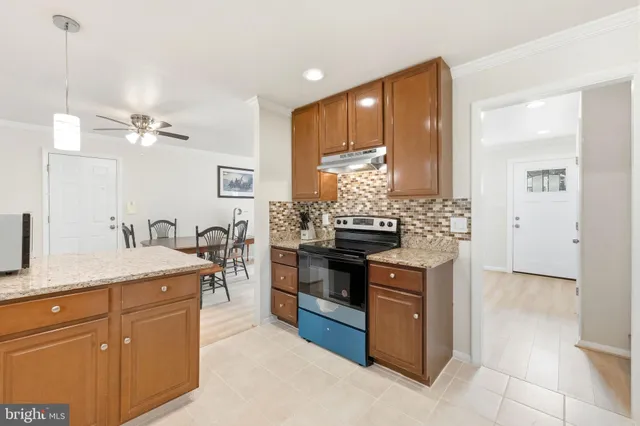 a kitchen with stainless steel appliances granite countertop a stove and a sink