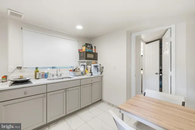 a kitchen with a refrigerator and a sink