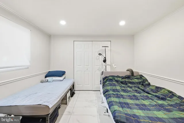 a view of a bedroom with workspace and bedroom