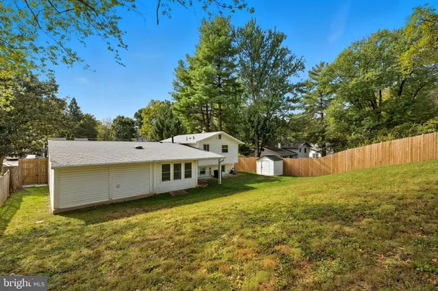 a view of a house with a yard and sitting area
