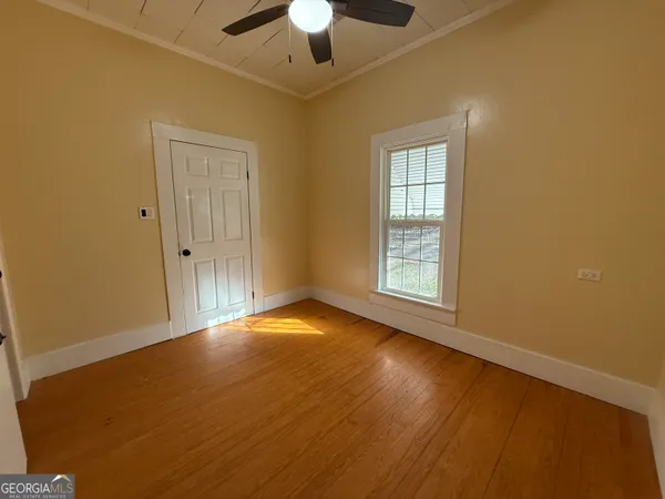a view of a livingroom with a ceiling fan and window