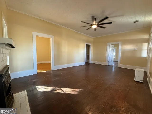 a view of a livingroom with a ceiling fan and window