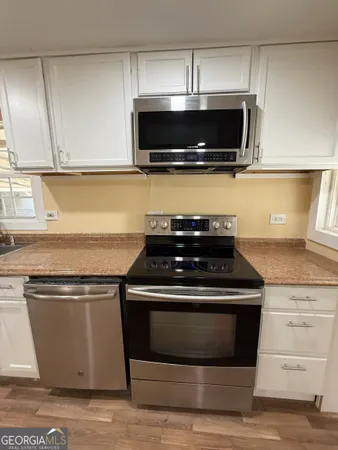 a view of a glass door and a living room filled with furniture
