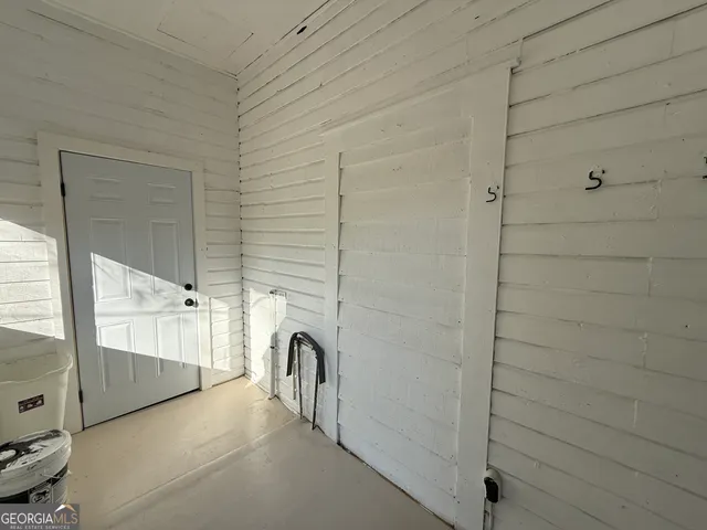 a view of a glass door and a living room filled with furniture