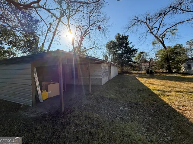 a view of a backyard with large trees