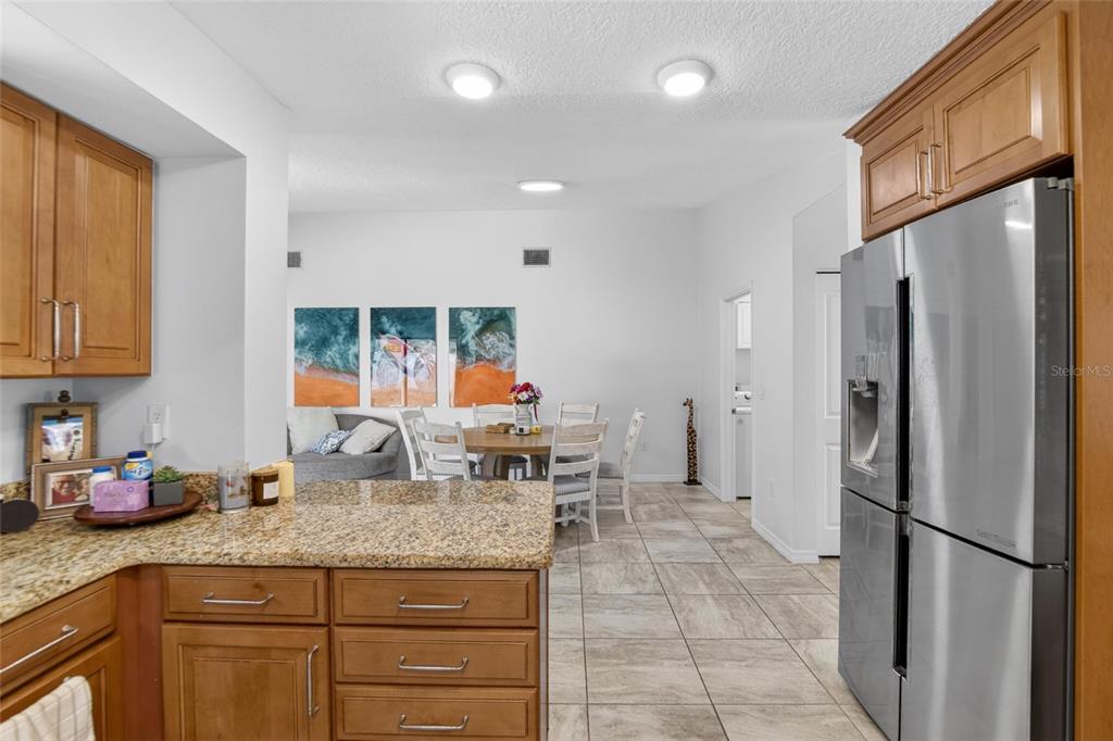 1668 Allens Ridge Drive North Palm Harbor, FL 34683 - Photo 13 of 48 a kitchen with stainless steel appliances granite countertop a refrigerator and a sink