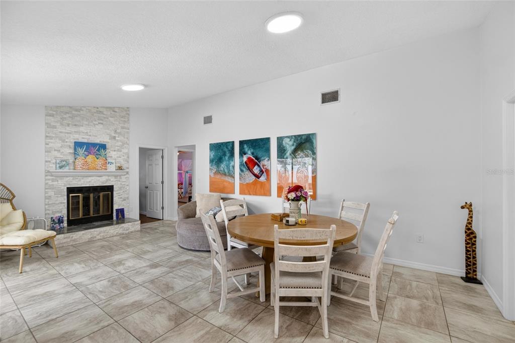 1668 Allens Ridge Drive North Palm Harbor, FL 34683 - Photo 15 of 48 a dining room with furniture and fireplace