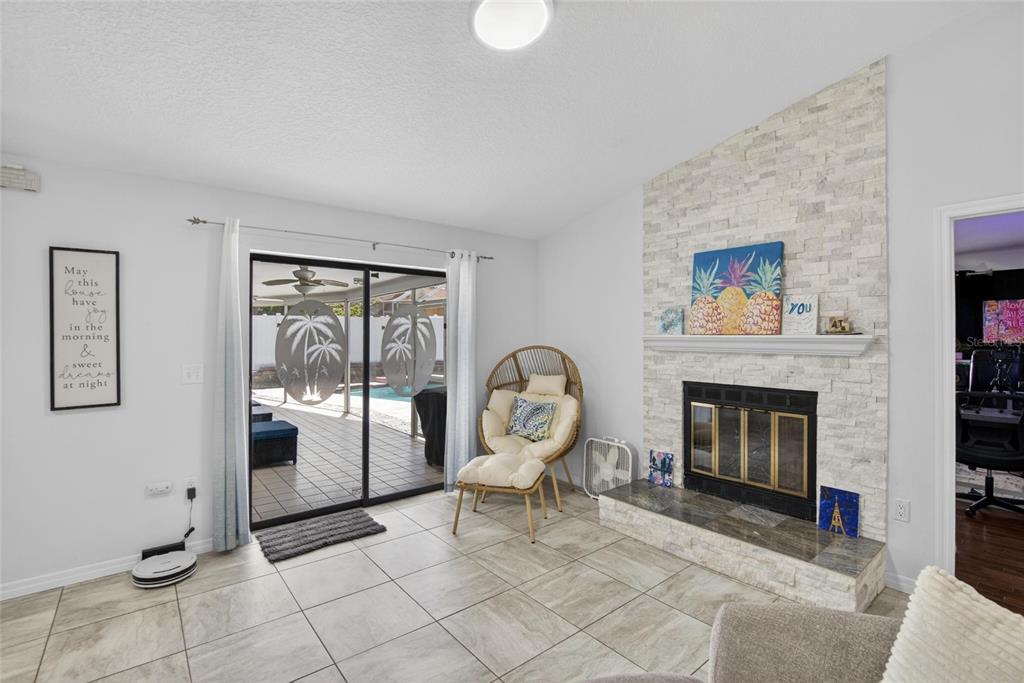 1668 Allens Ridge Drive North Palm Harbor, FL 34683 - Photo 16 of 48 a living room with furniture and a fireplace