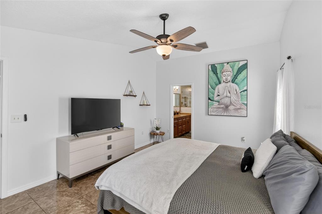 1668 Allens Ridge Drive North Palm Harbor, FL 34683 - Photo 20 of 48 a bedroom with a bed and a flat screen tv