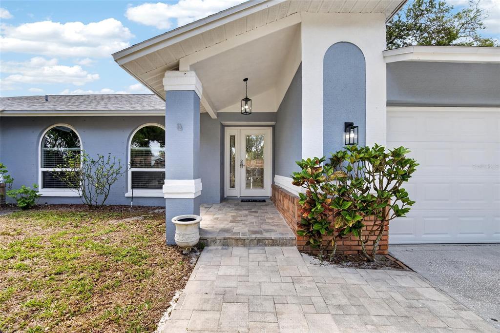1668 Allens Ridge Drive North Palm Harbor, FL 34683 - Photo 3 of 48 a front view of a house with garden