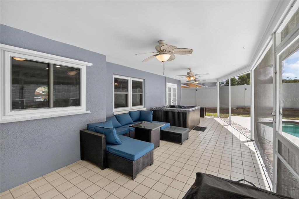 1668 Allens Ridge Drive North Palm Harbor, FL 34683 - Photo 34 of 48 a living room with couches and pool with wooden floor