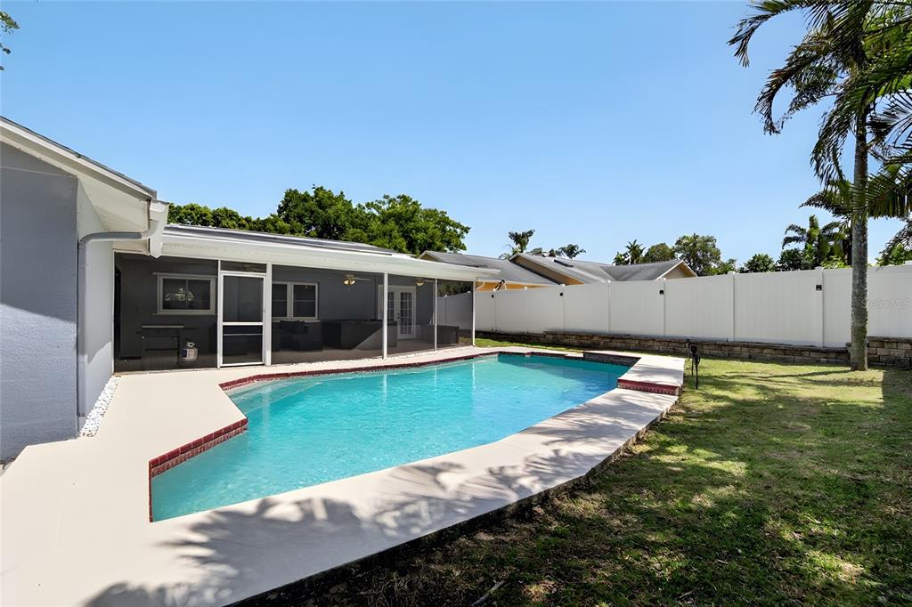 1668 Allens Ridge Drive North Palm Harbor, FL 34683 - Photo 37 of 48 a view of a house with pool and a yard