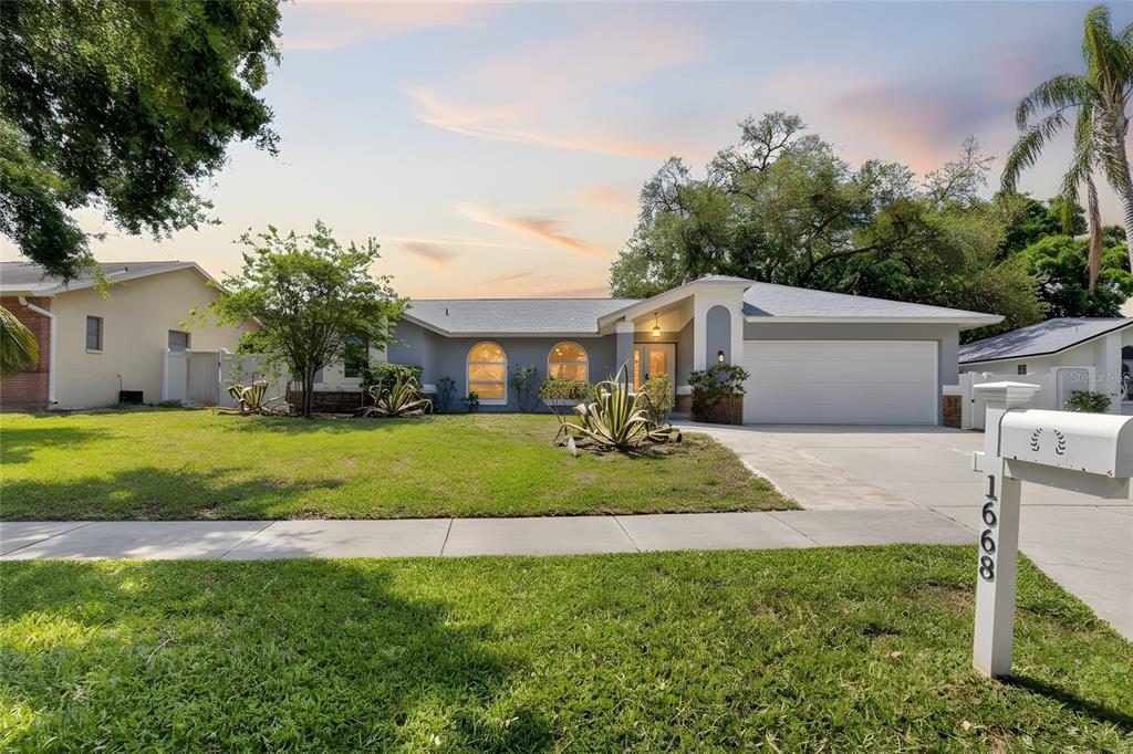 1668 Allens Ridge Drive North Palm Harbor, FL 34683 - Photo 48 of 48 a front view of a house with a yard and garage