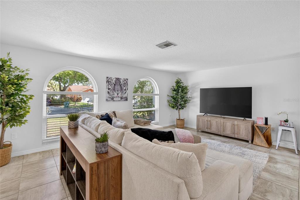 1668 Allens Ridge Drive North Palm Harbor, FL 34683 - Photo 6 of 48 a living room with furniture and a flat screen tv