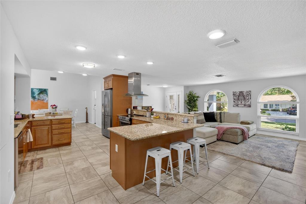1668 Allens Ridge Drive North Palm Harbor, FL 34683 - Photo 10 of 48 a dining hall with stainless steel appliances kitchen island granite countertop a sink and a refrigerator