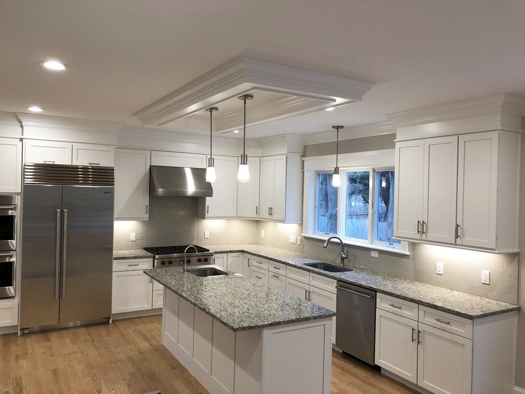 88 Bridge Street Lexington, MA 02421 - Photo 3 of 30 a kitchen with stainless steel appliances granite countertop a sink stove and refrigerator