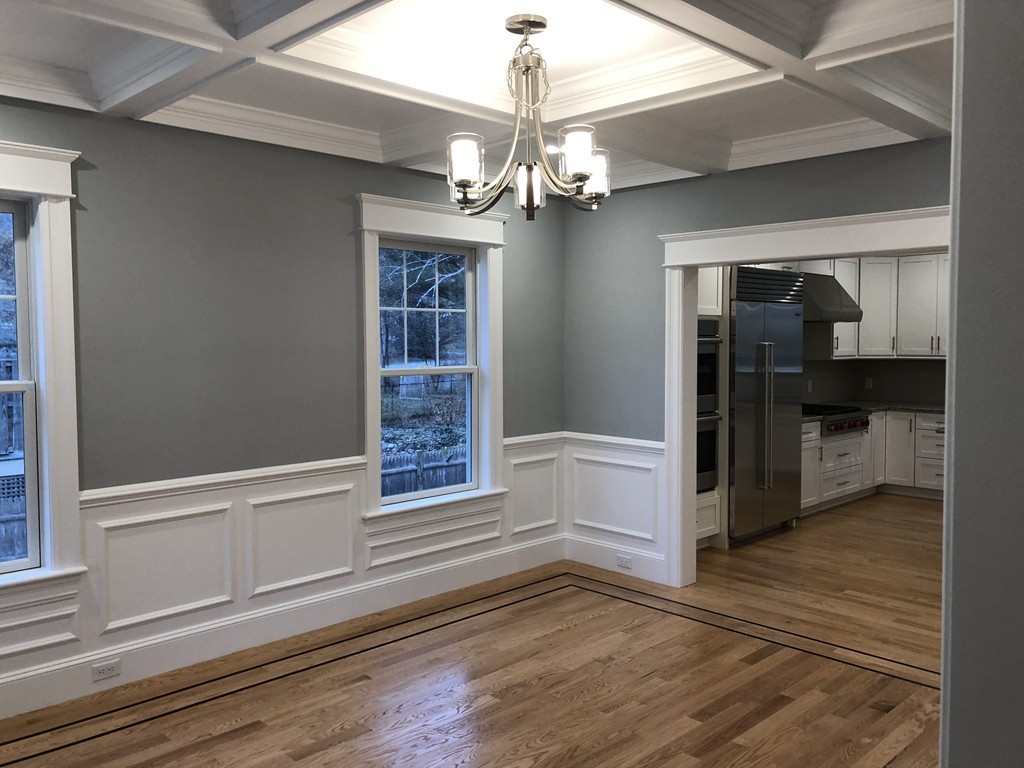 88 Bridge Street Lexington, MA 02421 - Photo 6 of 30 wooden floor in an empty room with a kitchen