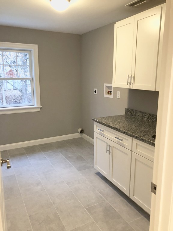 88 Bridge Street Lexington, MA 02421 - Photo 10 of 30 a kitchen with granite countertop white cabinets and a granite counter tops