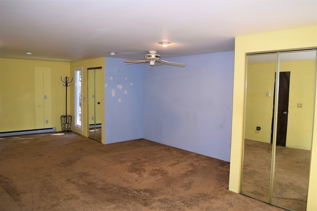 641 Wheelwright Road Barre, MA 01005 - Photo 15 of 26 an empty room with closet and a chandelier fan