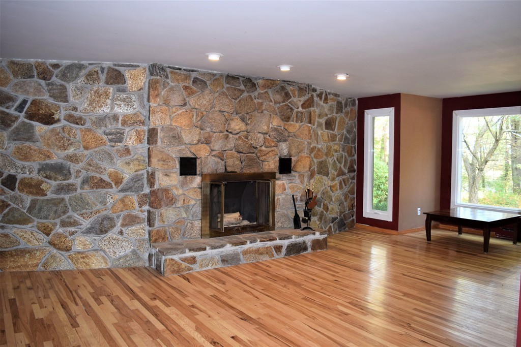 641 Wheelwright Road Barre, MA 01005 - Photo 4 of 26 wooden floor in an empty room with a fireplace